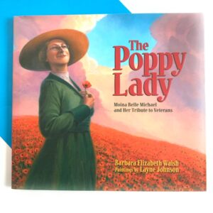 Image of veterans day book cover showing woman with a hat in a field of flowers