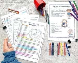 Woman's hand and crayons with teaching worksheets