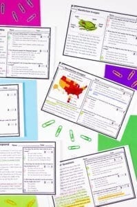 Notebook showing many exit ticket passages on half sheets of paper with colored construction paper behind each of them. 