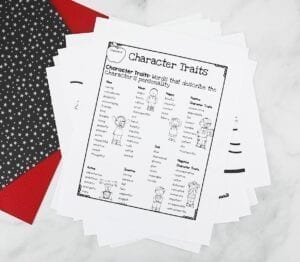 Character traits worksheet in black in white with colored paper behind it.