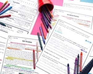 Digital and printable reading passages on a table with crayons and a pink background