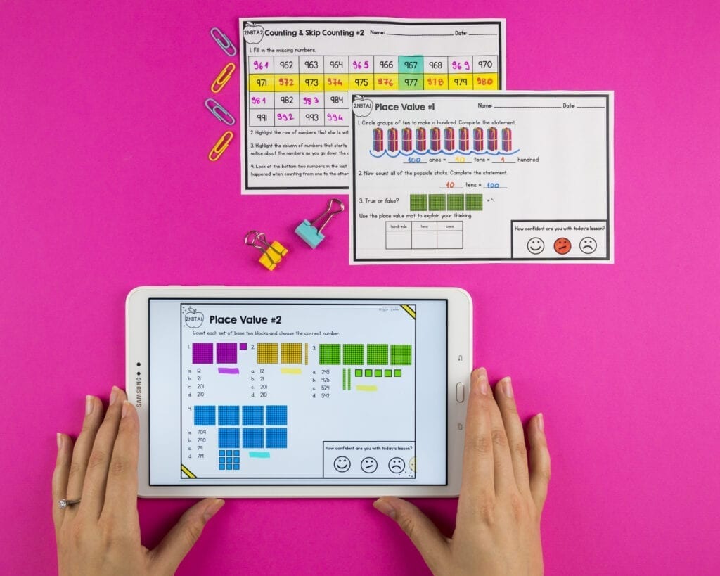 hands holding tablet with images of printable and digital math exit tickets 